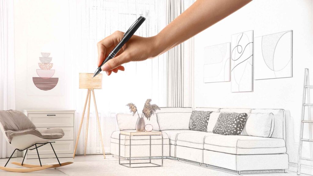 Une personne dessine un salon avec une chaise et un canapé.