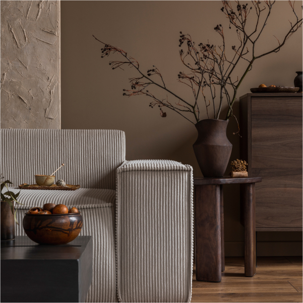 Un salon avec un canapé, une table et un vase.