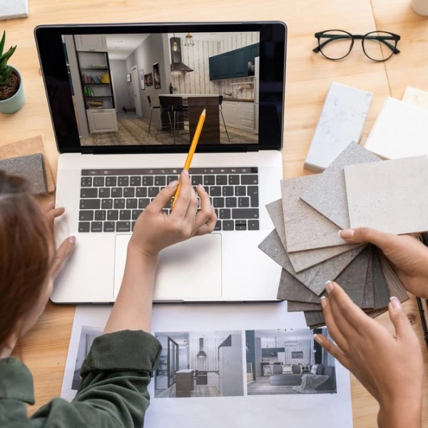 Two people discussing color palettes in front of a laptop