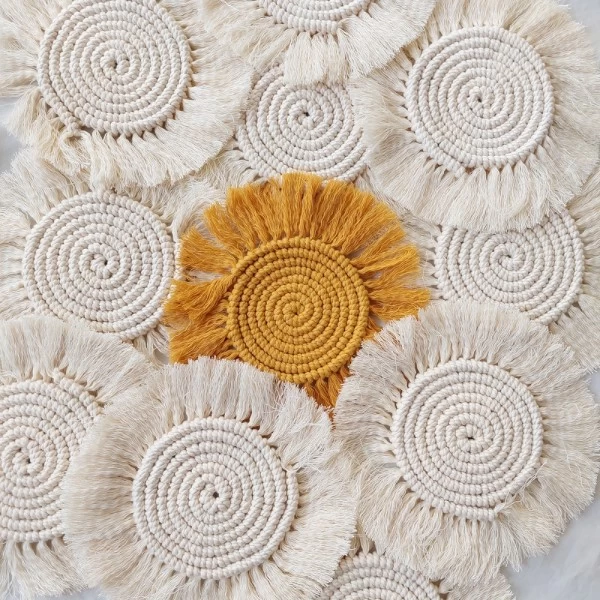 a group of white and yellow woven coasters