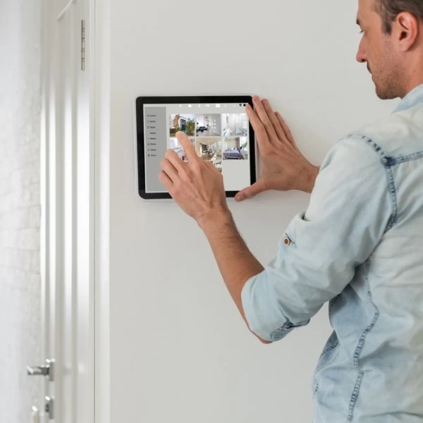 A person using a tablet leaning on a wall
