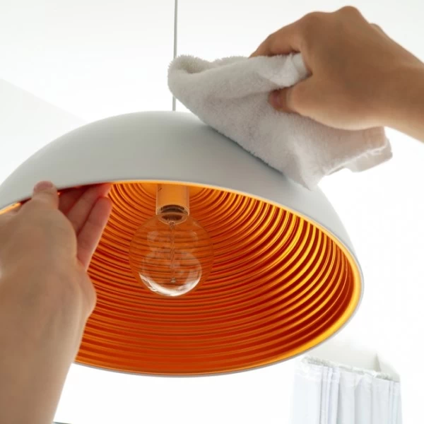 A lamp being cleaned